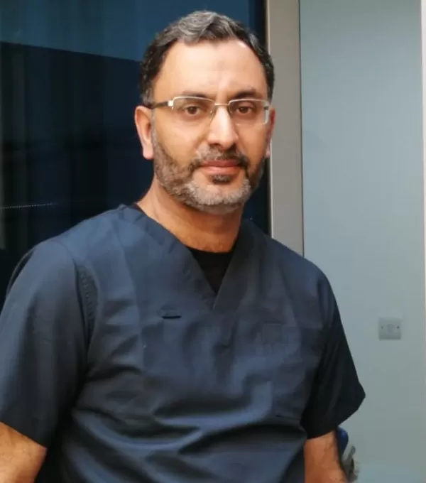 Male dental professional wearing black scrubs