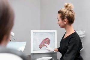 doctor performing intra oral scanning of teeth of patient
